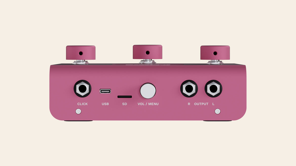 A piece of cake back panel in pink: click output, USB-C, SD card slot, volume and menu knob, stereo outputs