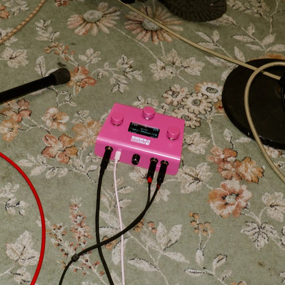 A piece of cake backing track player on a floral-patterned carpet