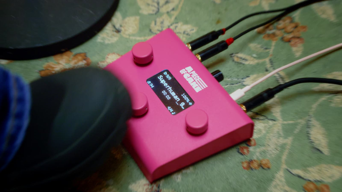 A piece of cake backing track pedal on stage, foot about to hit the footswitch