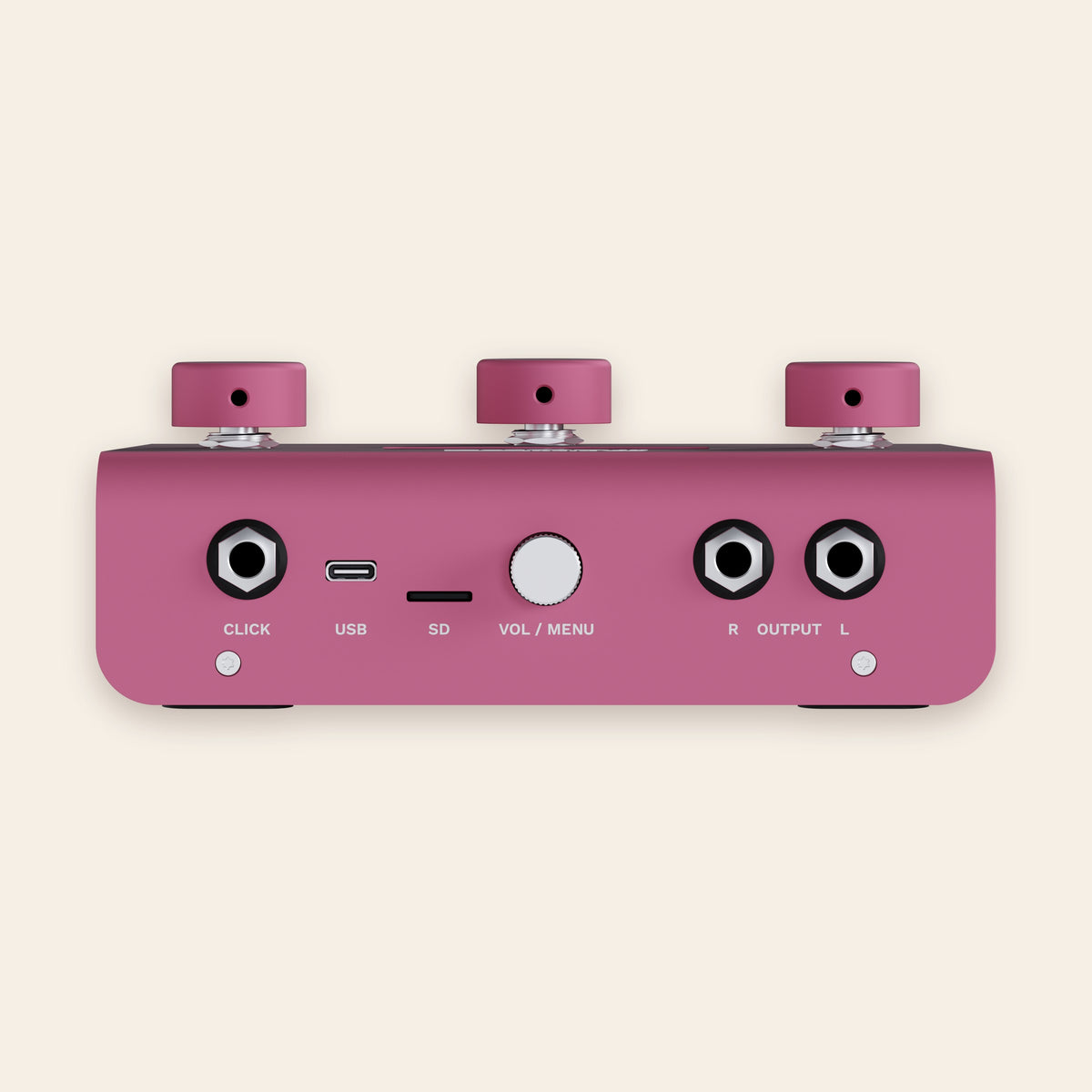 A piece of cake back panel in pink: click output, USB-C, SD card slot, volume and menu knob, stereo outputs