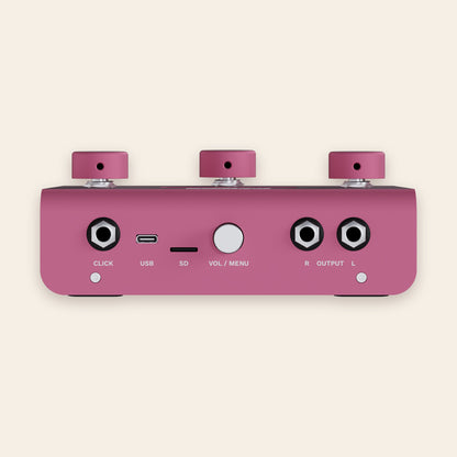A piece of cake back panel in pink: click output, USB-C, SD card slot, volume and menu knob, stereo outputs