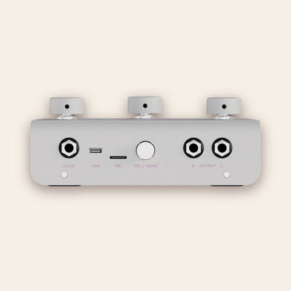 A piece of cake back panel in silver: click output, USB-C, SD card slot, volume and menu knob, stereo outputs